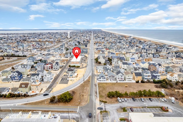 birds eye view of property featuring a view of the beach and a water view