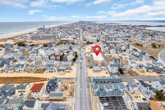 bird's eye view featuring a water view and a view of the beach