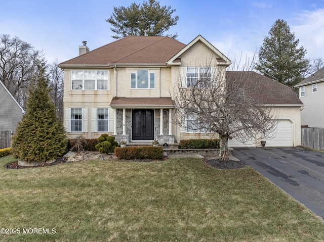 front of property with a front yard and a garage