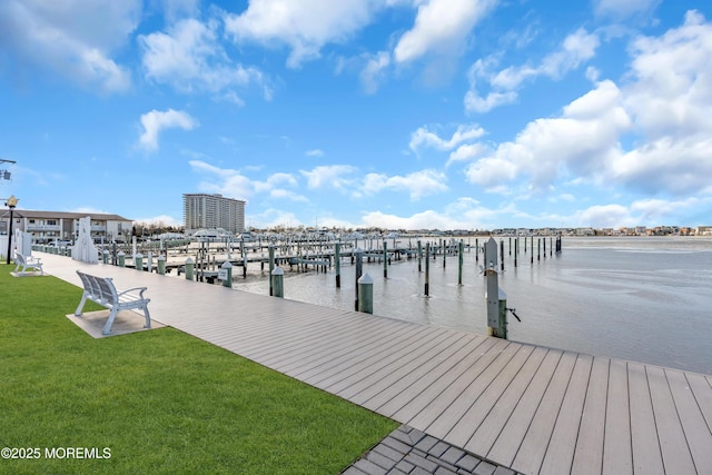 dock area featuring a water view and a lawn