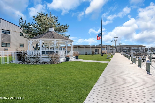 dock area with a gazebo, cooling unit, and a lawn