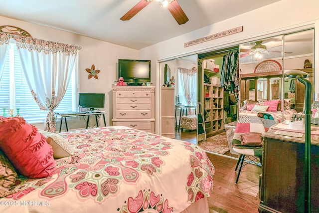 bedroom with wood-type flooring, a closet, and ceiling fan