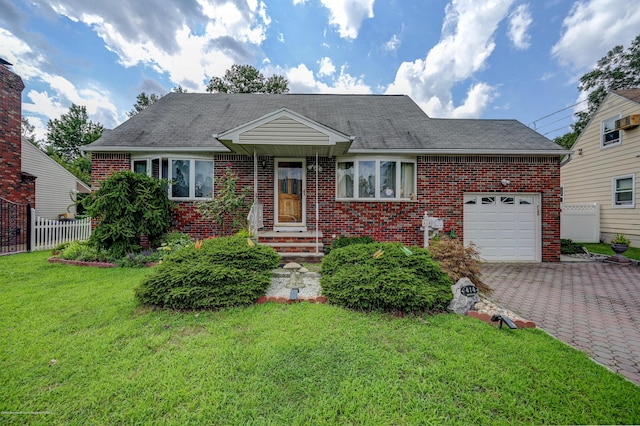 view of front of house featuring a garage and a front lawn