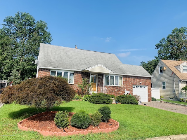 view of front of home with a garage and a front lawn