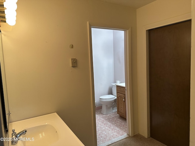 bathroom featuring toilet and vanity