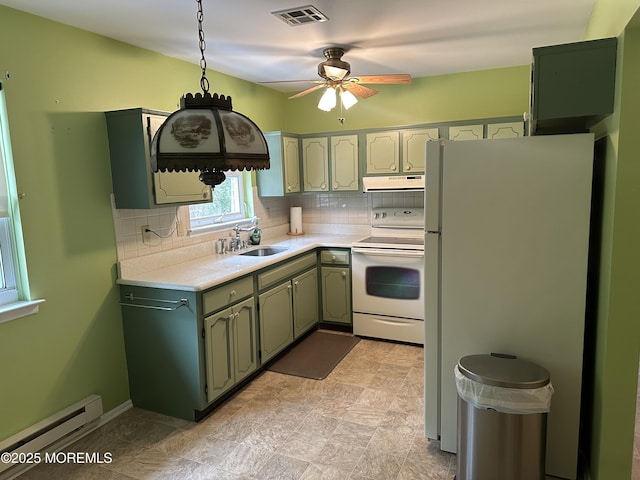 kitchen featuring white appliances, decorative backsplash, sink, and a baseboard heating unit