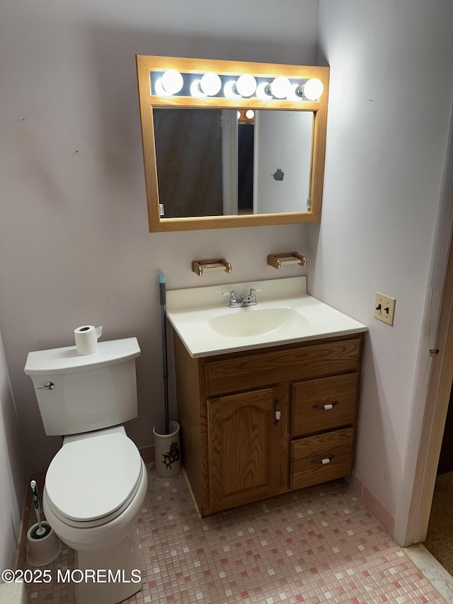 bathroom with tile patterned flooring, vanity, and toilet