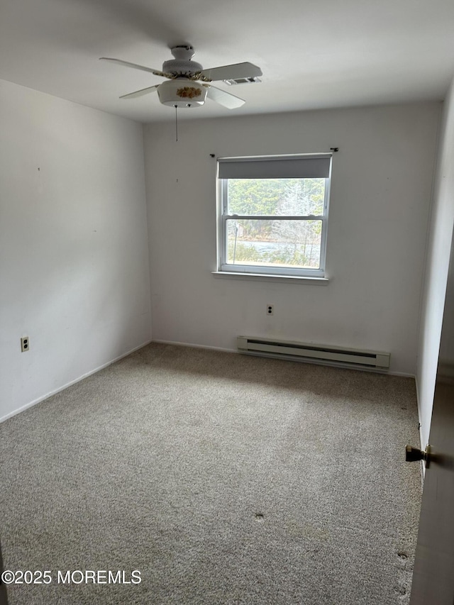 unfurnished room featuring a baseboard heating unit, ceiling fan, and carpet