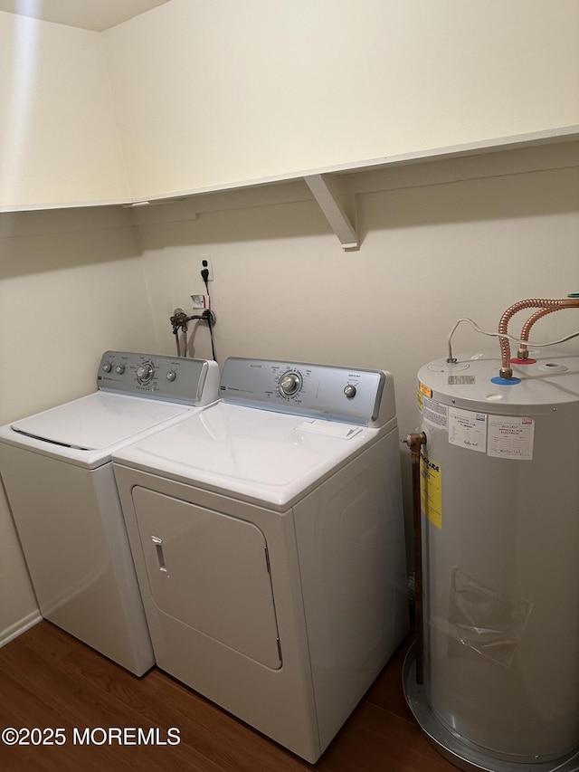 laundry room with independent washer and dryer, water heater, and dark hardwood / wood-style floors