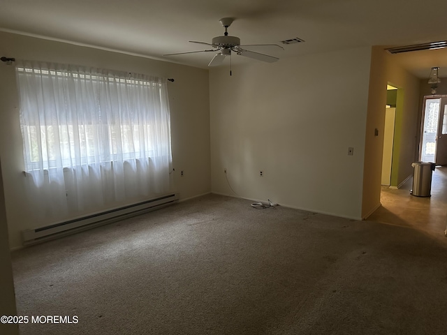 carpeted spare room featuring a baseboard heating unit and ceiling fan