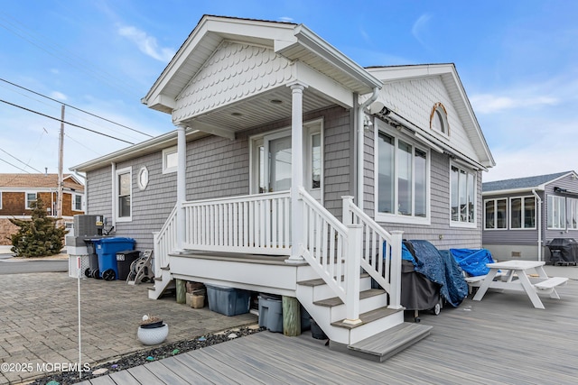 view of front of property featuring a patio and cooling unit