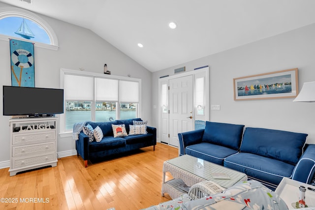 living room with hardwood / wood-style flooring and vaulted ceiling