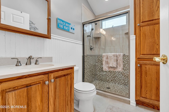 bathroom featuring tile patterned flooring, an enclosed shower, vanity, and toilet