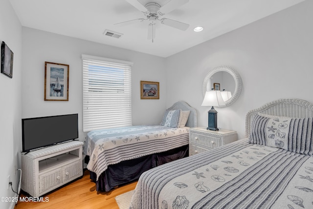 bedroom with ceiling fan and hardwood / wood-style floors