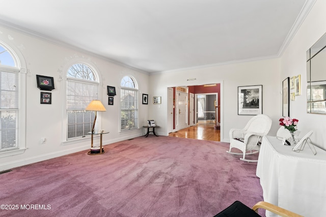 sitting room with ornamental molding and light colored carpet