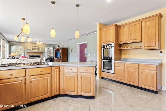 kitchen featuring appliances with stainless steel finishes, a notable chandelier, light tile patterned floors, and hanging light fixtures