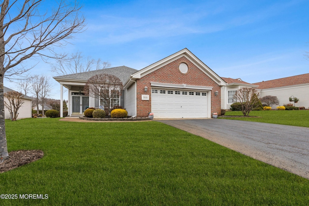 ranch-style house featuring a garage and a front yard