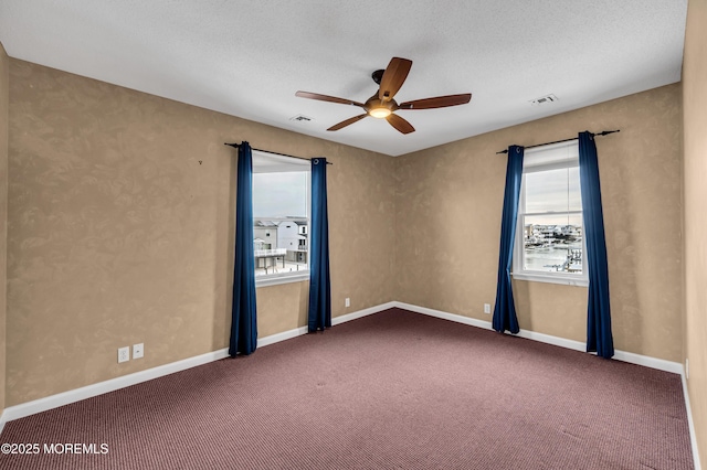 unfurnished room with carpet floors, a textured ceiling, and ceiling fan