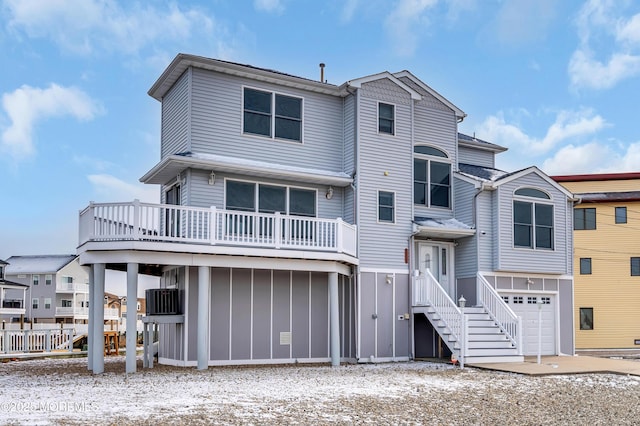 view of front facade featuring a garage and cooling unit