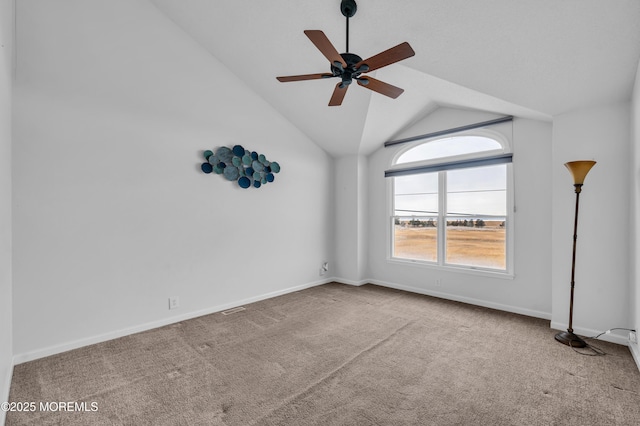 carpeted empty room featuring ceiling fan and lofted ceiling