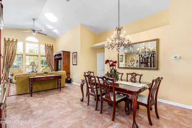 tiled dining room with lofted ceiling and ceiling fan with notable chandelier