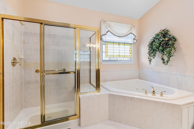 bathroom with independent shower and bath and tile patterned flooring