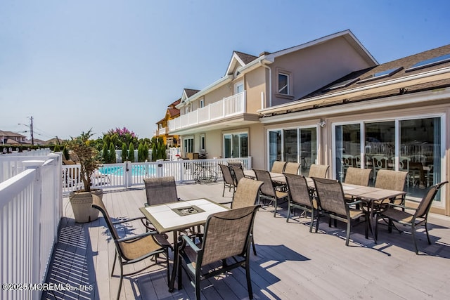 wooden deck with a fenced in pool