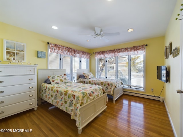 bedroom featuring a baseboard radiator, dark hardwood / wood-style floors, and ceiling fan