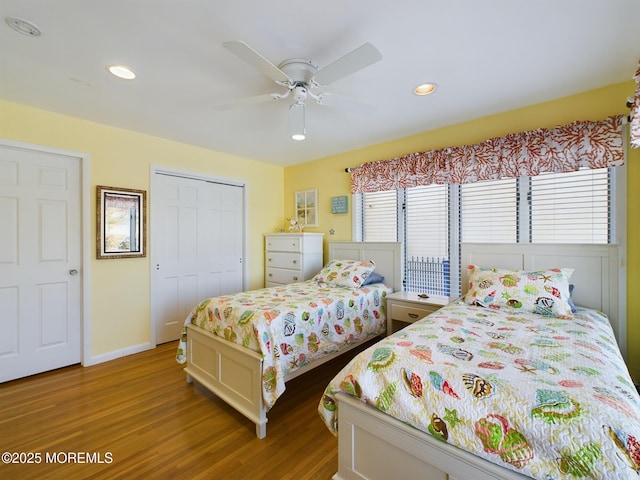 bedroom featuring wood-type flooring, a closet, and ceiling fan