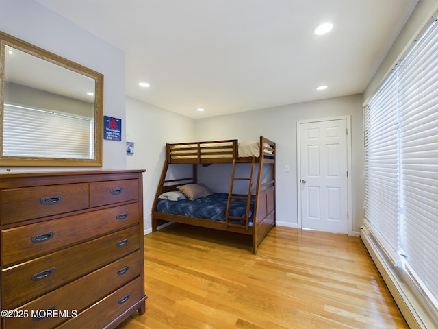 bedroom featuring light hardwood / wood-style flooring and a baseboard radiator