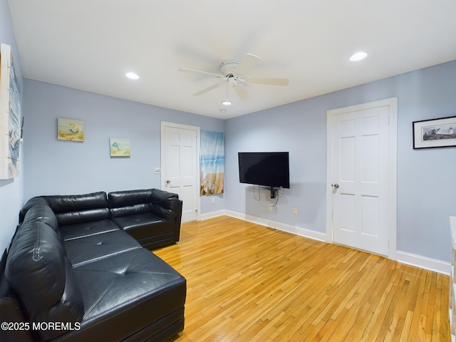 living room featuring wood-type flooring and ceiling fan