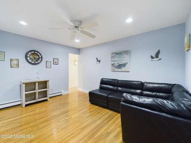 living room with light hardwood / wood-style floors and ceiling fan