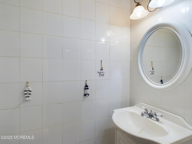 bathroom with sink and tile walls