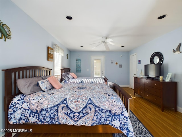 bedroom featuring hardwood / wood-style flooring and ceiling fan