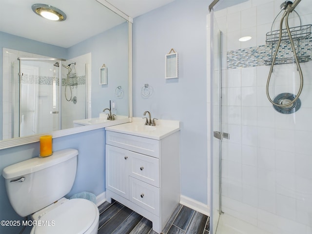 bathroom featuring vanity, an enclosed shower, and toilet