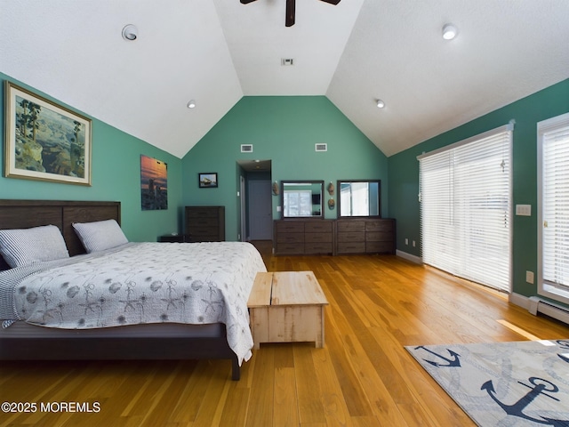 bedroom featuring baseboard heating, ceiling fan, lofted ceiling, and light hardwood / wood-style floors