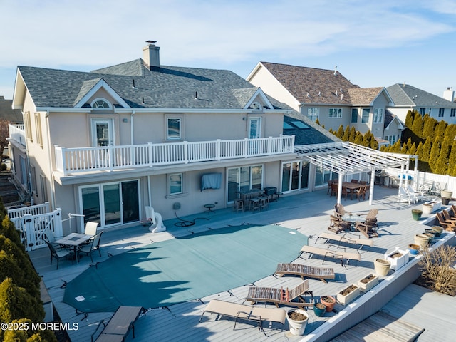 back of house with a balcony and a pergola