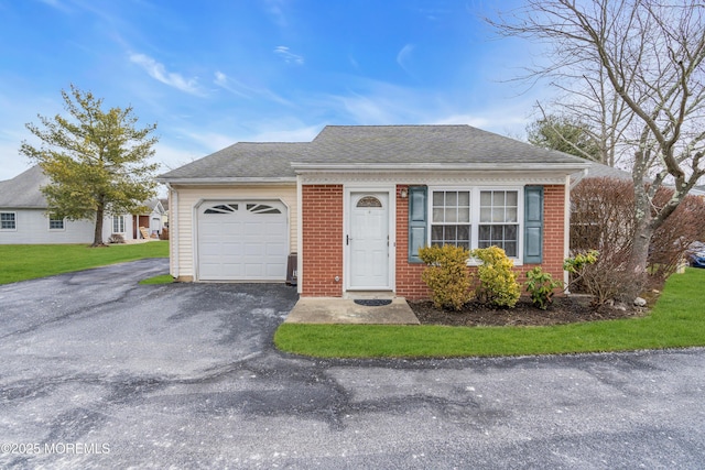 view of front of house with a front yard and a garage