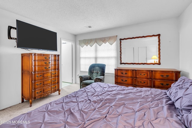 carpeted bedroom featuring a textured ceiling