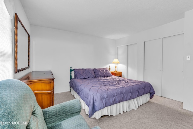 carpeted bedroom with multiple closets