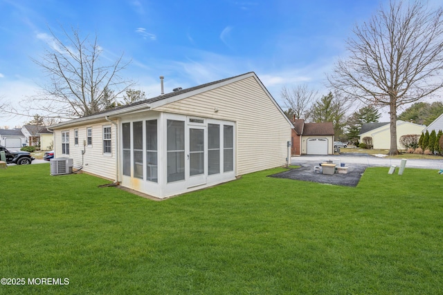 back of house featuring a yard, central air condition unit, and a sunroom