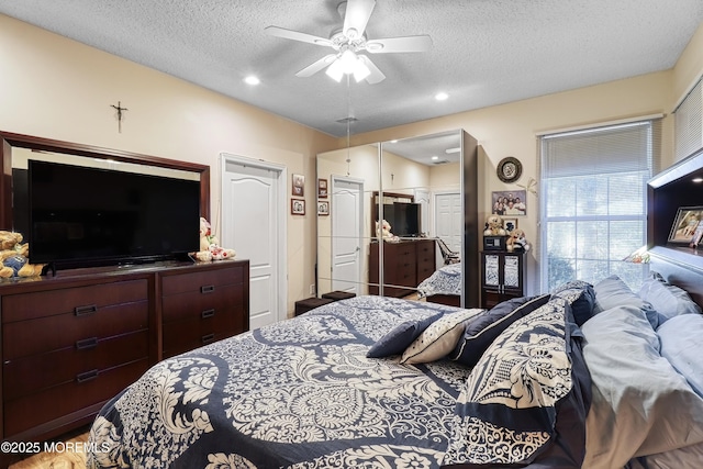 bedroom with a textured ceiling and ceiling fan