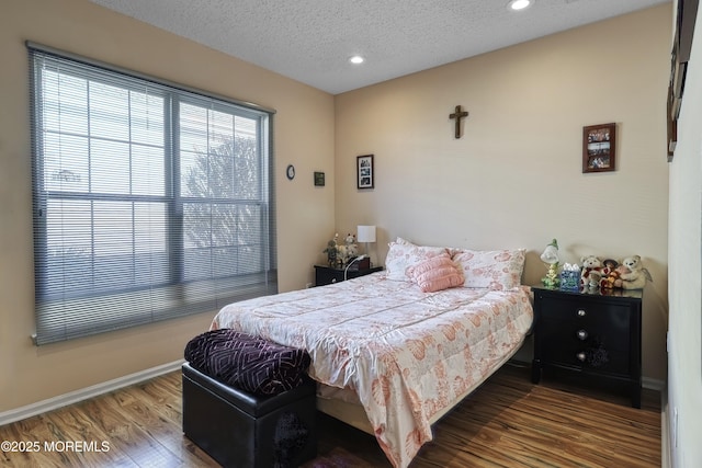 bedroom featuring a textured ceiling and hardwood / wood-style floors