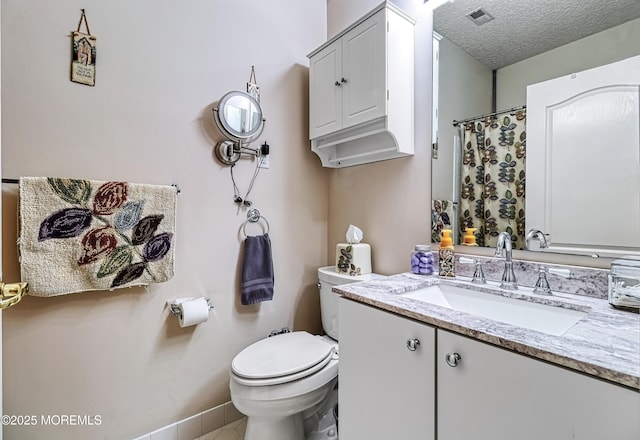 bathroom with toilet, a textured ceiling, and vanity