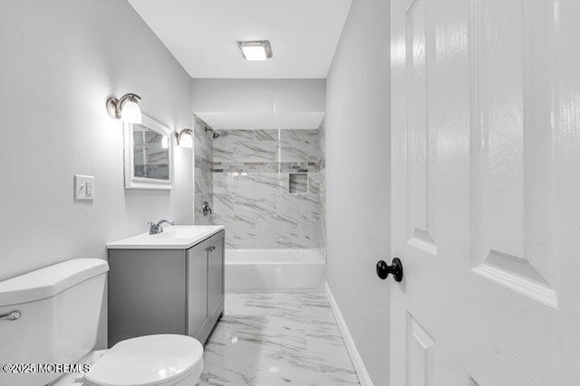 full bathroom with tiled shower / bath, vanity, and toilet