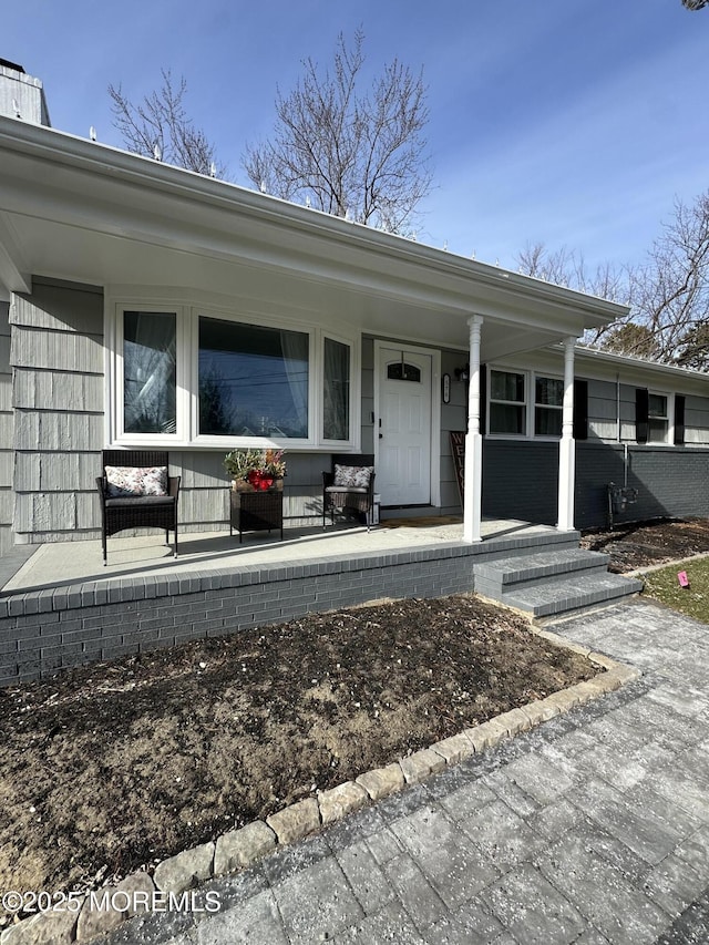 view of exterior entry with a porch