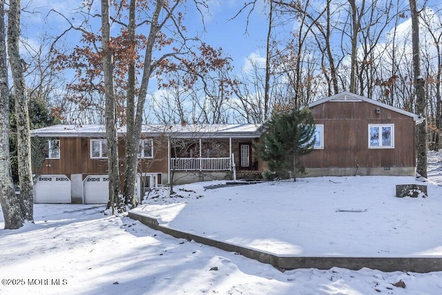 single story home featuring a porch and a garage