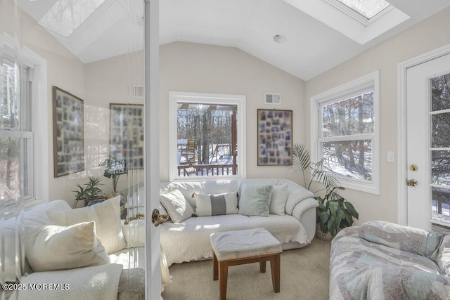 carpeted living room featuring lofted ceiling with skylight