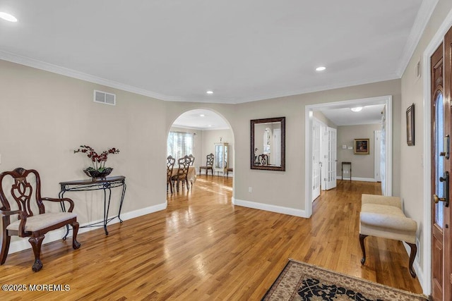 hall featuring crown molding and light wood-type flooring