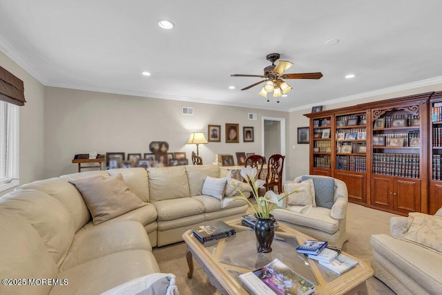 living room featuring ceiling fan, ornamental molding, and light carpet